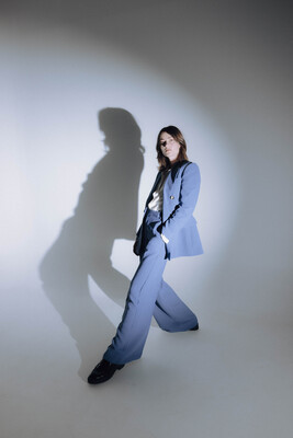 Rowena Wise wearing a blue suit with a light on her