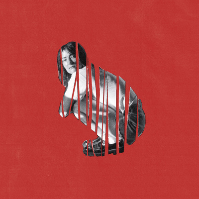 Rowena Wise crouching with a red background